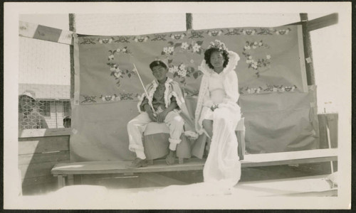 Children sitting in front of floral background