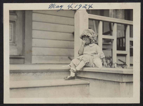 Young girl sitting on porch