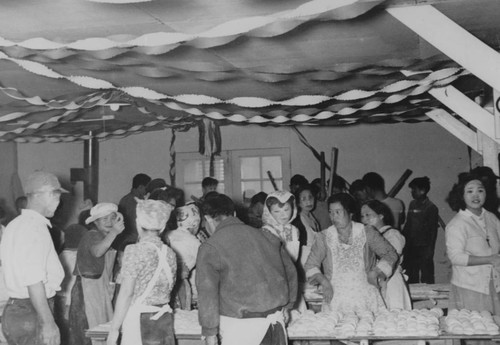 People around food tables at a celebration