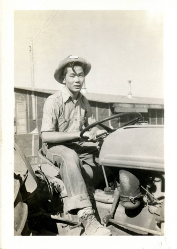 [Young man on tractor]