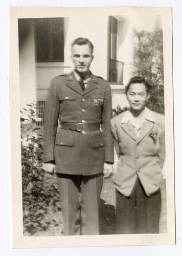 John Yoshinaga standing next to military man