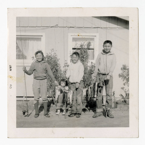 Lonnie, Diana, Glen, and Howard Jr. holding fishing poles