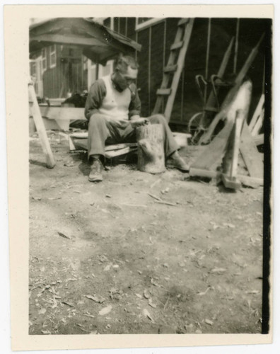 Man sitting on wood at Jerome incarceration camp