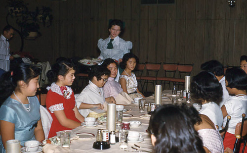 Girls sitting at long table during Jr. Miss Christmas party