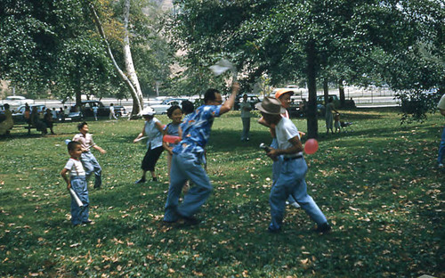 Women, men, and children playing a game