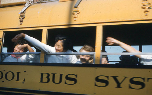 Girls waving on school bus