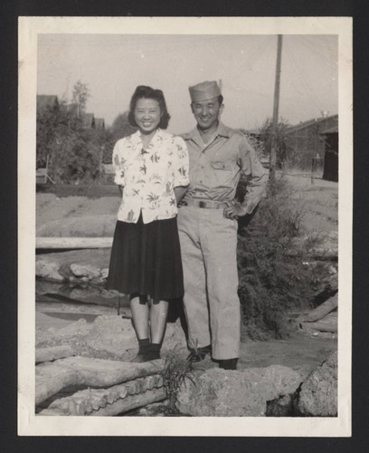 Uniformed Mitsuru Yagura standing next to woman at Poston incarceration camp