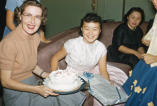 Woman holding cake at Jr. Misses event