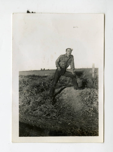 Nisei man standing on a bank