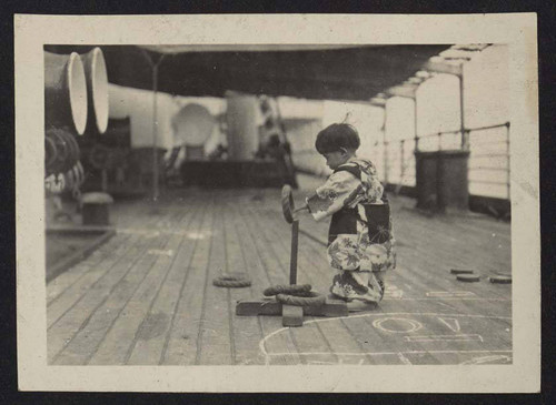 Child playing on boatdeck