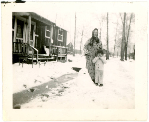 Shigeru Yoshinaga standing next to young child at Jerome incarceration camp