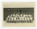 Group of Nisei 8th graders with a teacher outside a barrack