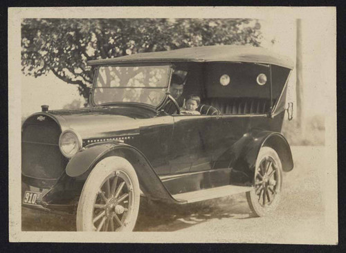 Man and child sitting in car