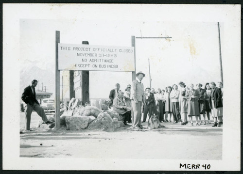 Photograph of Ralph Merritt officially closing Manzanar with his dog Sandy at his feet