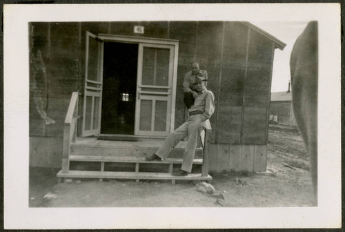 Men outside camp barrack