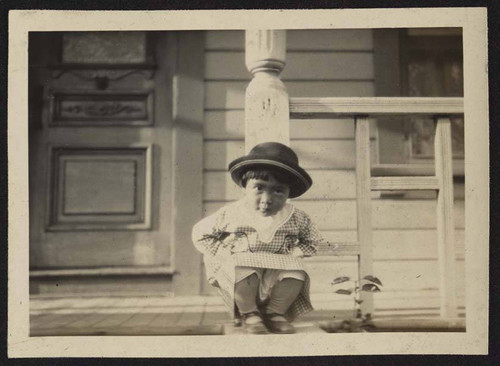 Young girl sitting on porch