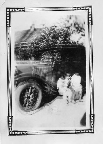 [Children on car running board]