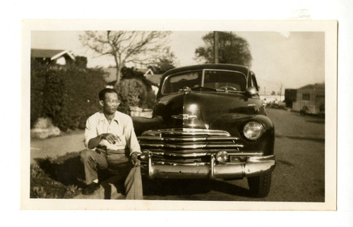 Manuel E. Ikari, with car