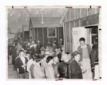 Nisei men gathered in front of barracks at Manzanar