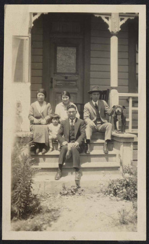 Men, women, and children on porch