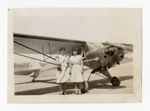 Dorothy Yuriko Treakle and Connie Takahashi in front of plane