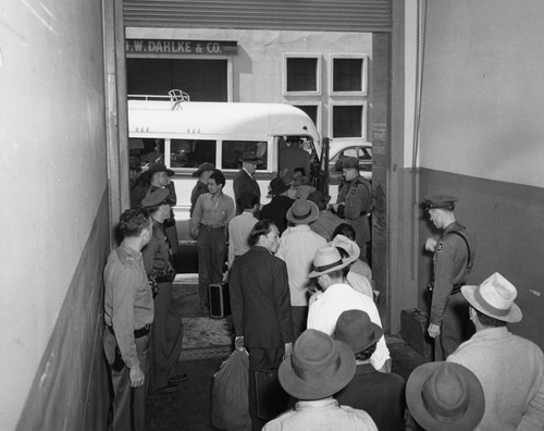 Indonesians boarding buses in San Francisco to be taken to a waiting train