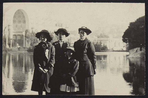 Women and girls in front of pond