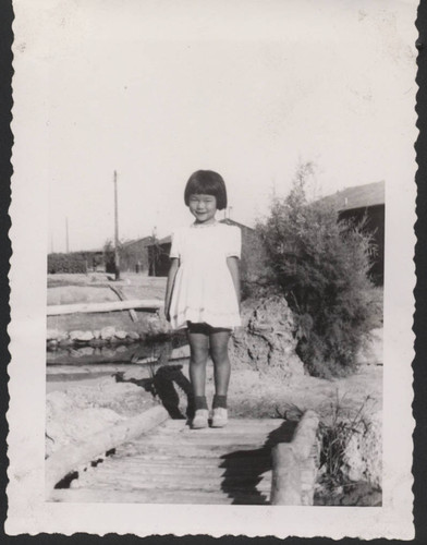Little girl on footbridge at Poston incarceration camp