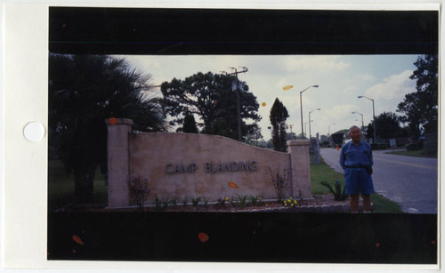 Joseph Isamu Fuchita standing next to Camp Blanding sign