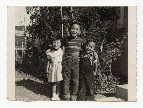 Howard Jr. "Butch," Lonnie and Glen Takahashi in front of house