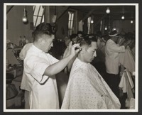 [Barber cutting hair]