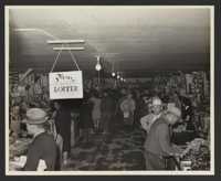 [Shoppers in camp store]