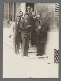 [Group photograph including: Enrico Fermi, Peter Debye, Werner Heisenberg, Otto Stern, Orso Mario Corbino, Niels Bohr, in front of building where group portraits at the Rome Conference on Nuclear Physics were made.]