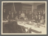 [Group snapshot including Otto Stern and large group around dinner table.]