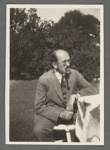 [Otto Stern siiting outside with pipe in mouth.]