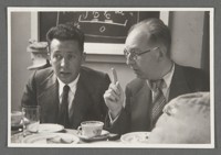 [Physics conference snapshot including Walter Heitler on left and Leon Rosenfeld on right, in Copenhagen?]
