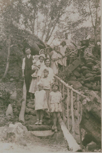 Clearwater family posing for a portrait by craftsman railings in Temescal Canyon, Calif