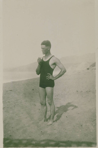 Tex Myers in bathing suit on the beach near the bath house in Santa Monica, Calif