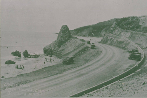 Automobiles parked by Castle Rock on the Pacific Coast Highway