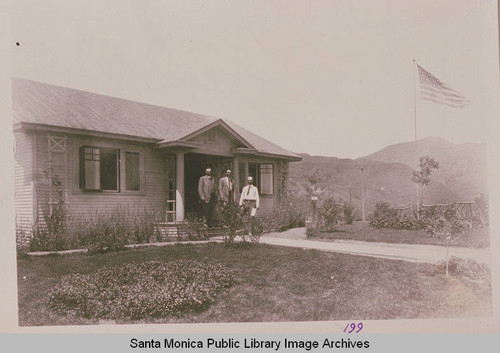 "The Bishop's Cottage" (original sales office for the entire area of Pacific Palisades) with an American flag flying