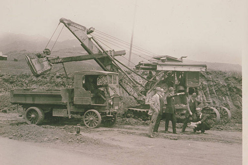 Inspectors by a steam shovel at a construction site in Hungtington Palisades, Calif