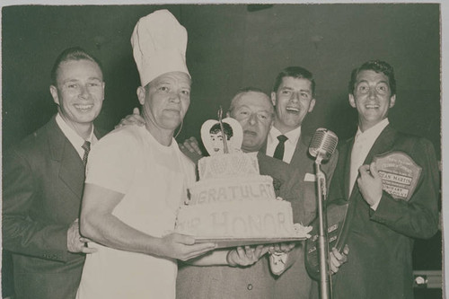 Comedians Jerry Lewis (second from right) and Dean Martin (far right) receiving a cake on their induction as Honorary Mayor and Honorary Chief of Police of Pacific Palisades respectively