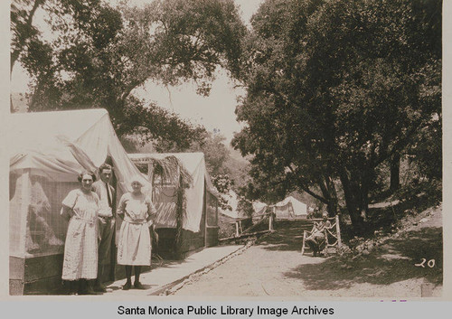 Campers stand in front of row of tents at Institute Camp in Temescal Canyon, Calif