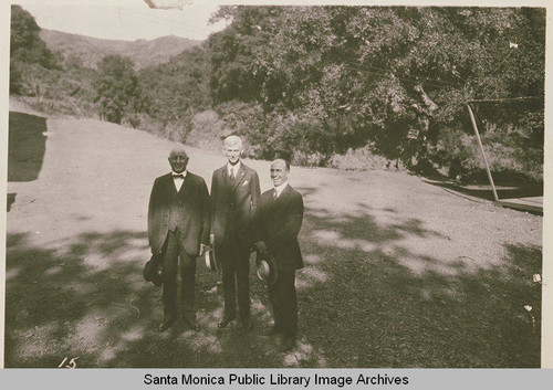 Men gathered at the Chautauqua Camp in Upper Temescal Canyon, including then-Governor of California William Stephens on the left, and Charles Scott on the right