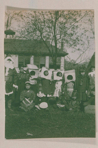 Marquez family and other children in costumes standing in front of Canyon School in Santa Monica Canyon