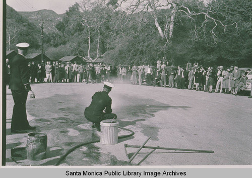 Firemen demonstrating how to extinguish phosphorus bombs in the event of an attack at Assembly Camp, Temescal Canyon, Calif