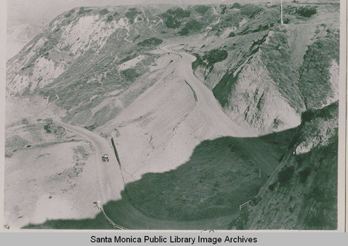 Looking down from Via de La Paz in Pacific Palisades as an automobile travels the road up from the beach