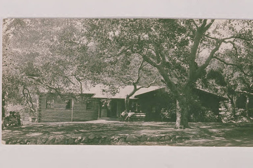 People sitting on a bench in front of the library at Assembly Camp in Temescal Canyon, Calif