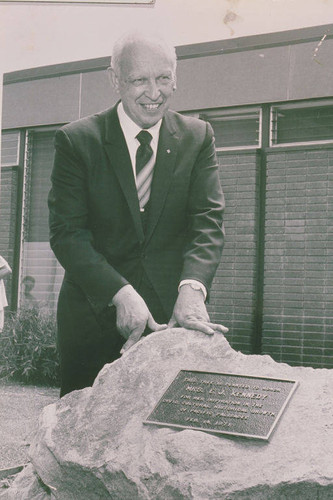 Portrait of Mr. Ysidro Reyes showing the plaque dedicated to Mrs. E.J. Kennedy for her "inspiration to the civic,cultural, historical growth of Pacific Palisades, February 14, 1971."