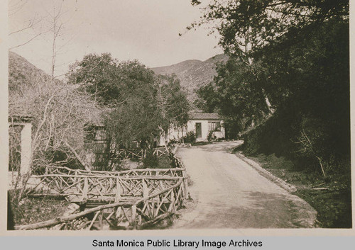 House in Spanish Colonial Revival style at Assembly camp with Craftsman railings showing the Santa Monica Mountains in the background